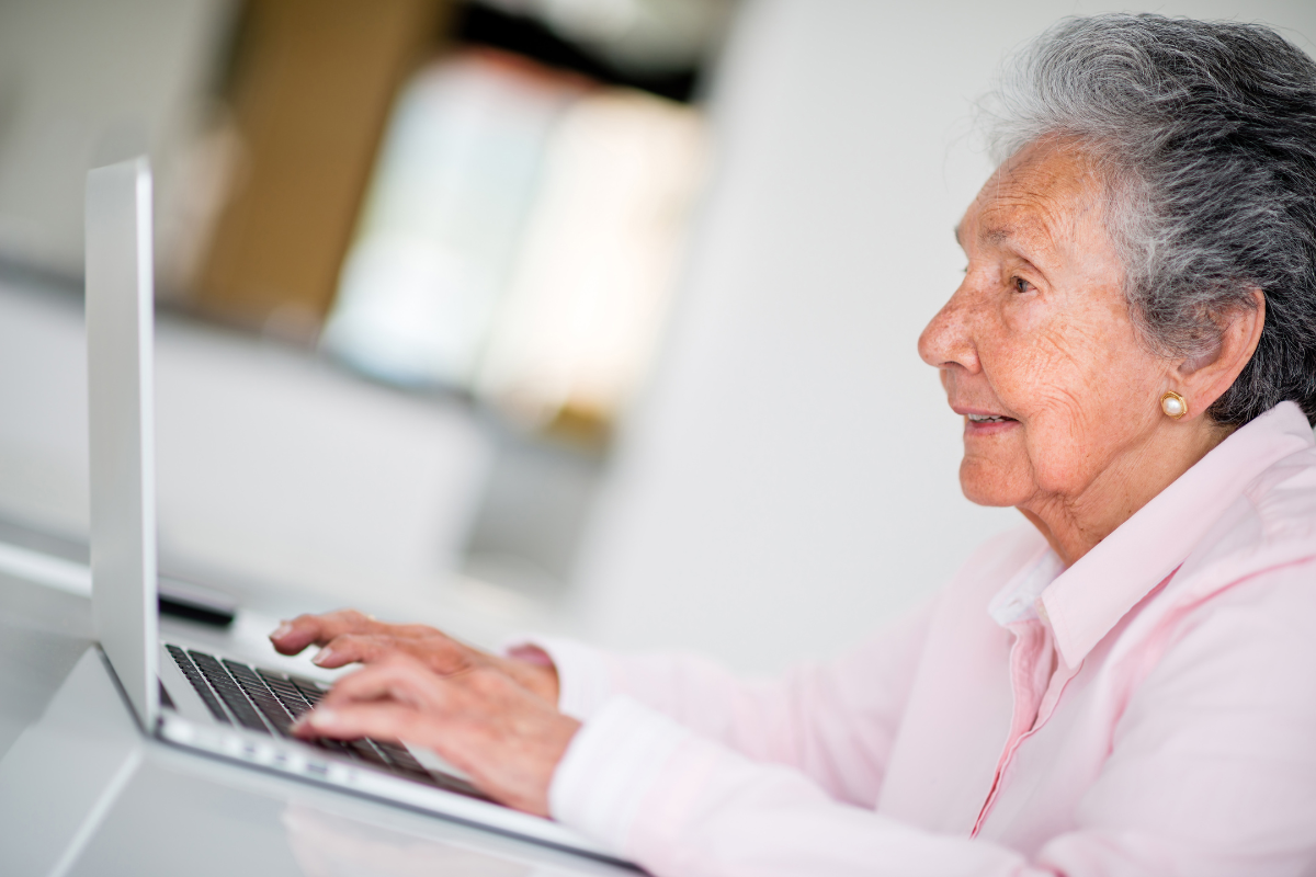 preventing the elderly against scammers | Image of an old lady using a laptop