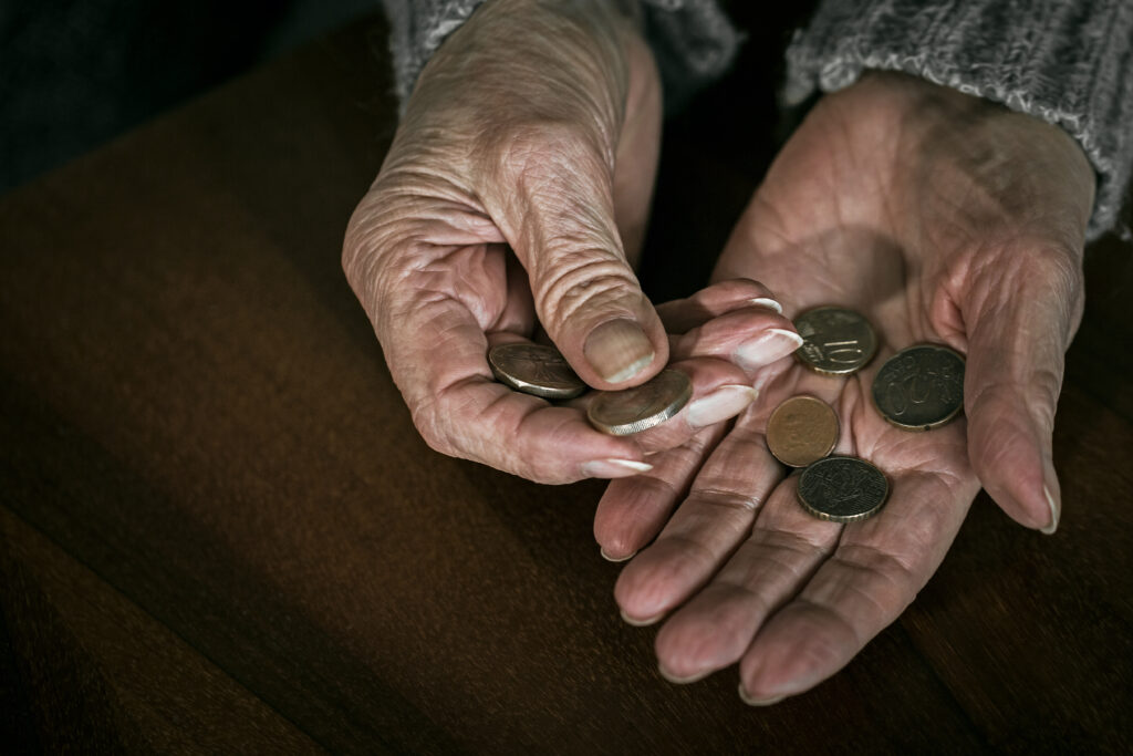 cost of living crisis affecting the elderly - image showing older lady counting last coins | care in Kent 