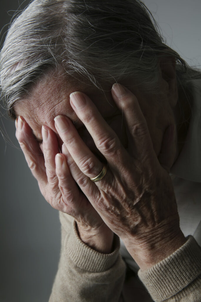 Senior woman covering face with her hands | seasonal depression | care in kent