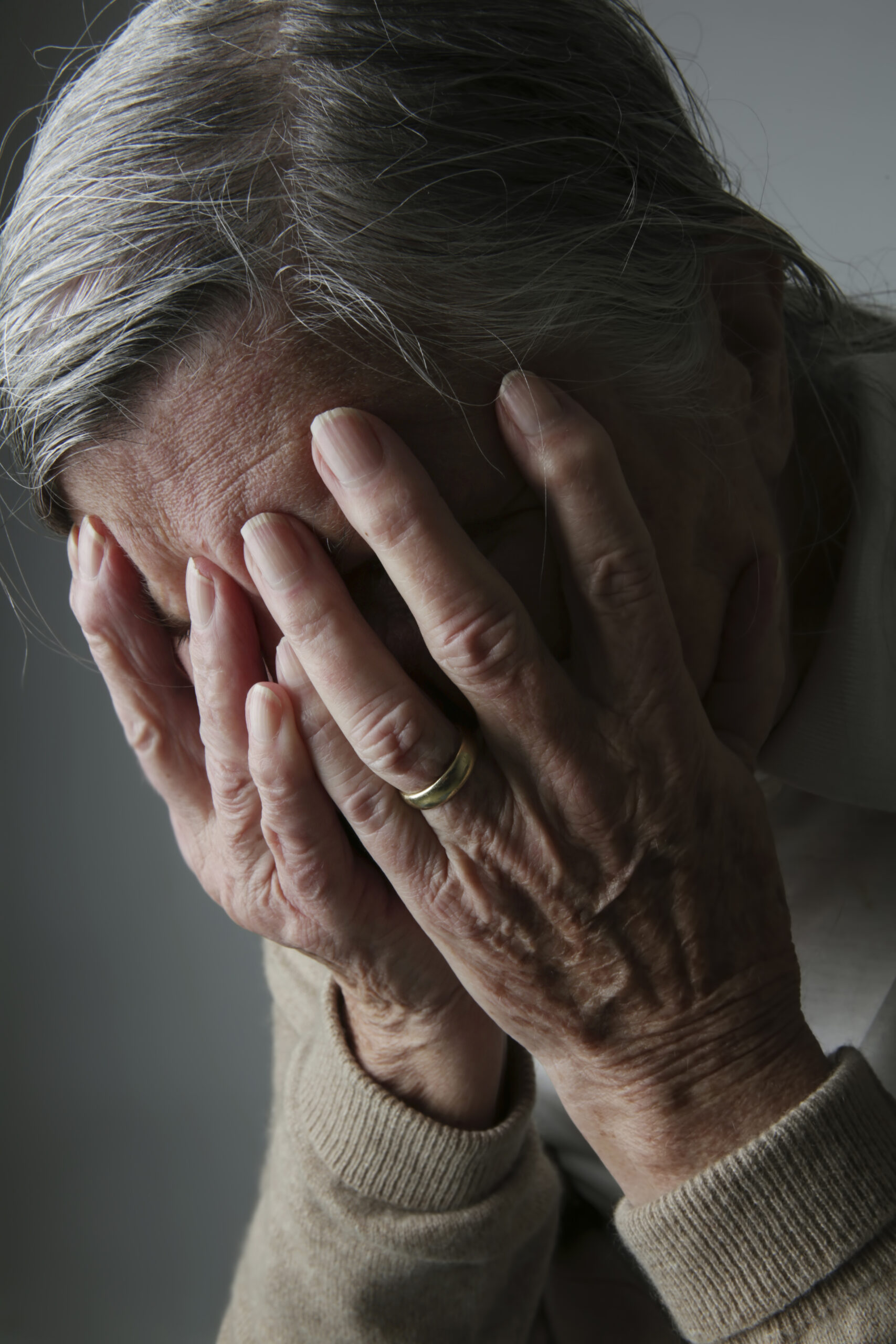 Senior woman covering face with her hands | seasonal depression | care in kent | grief stages